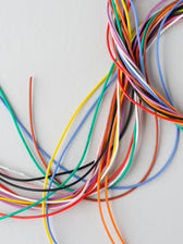 Colourful electrical wires on a light background, photographed by Kier in Sight Archives